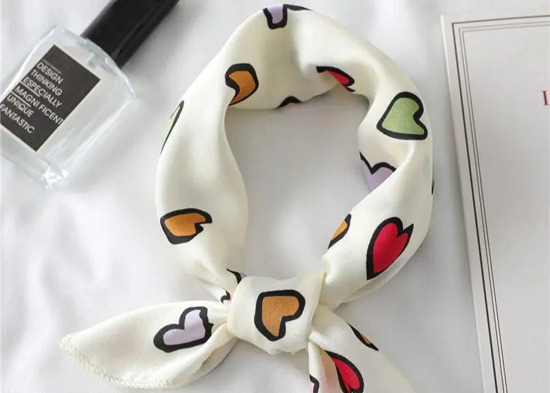 Elegant silk scarf featuring a charming heart print, perfect fashion accessory for women seeking stylish looks.