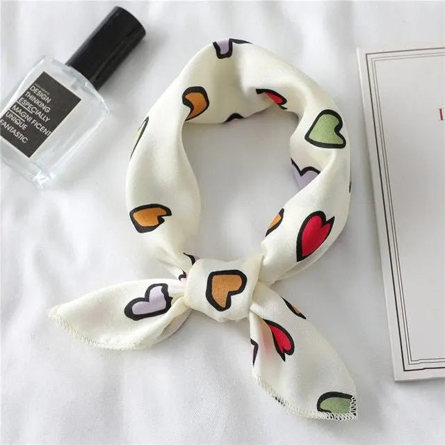 Elegant silk scarf featuring a charming heart print, perfect fashion accessory for women seeking stylish looks.